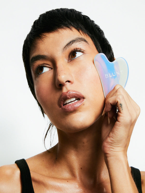 Rolling Stone Gua Sha Face Massage Tool by Blunt Skincare Model Using Product